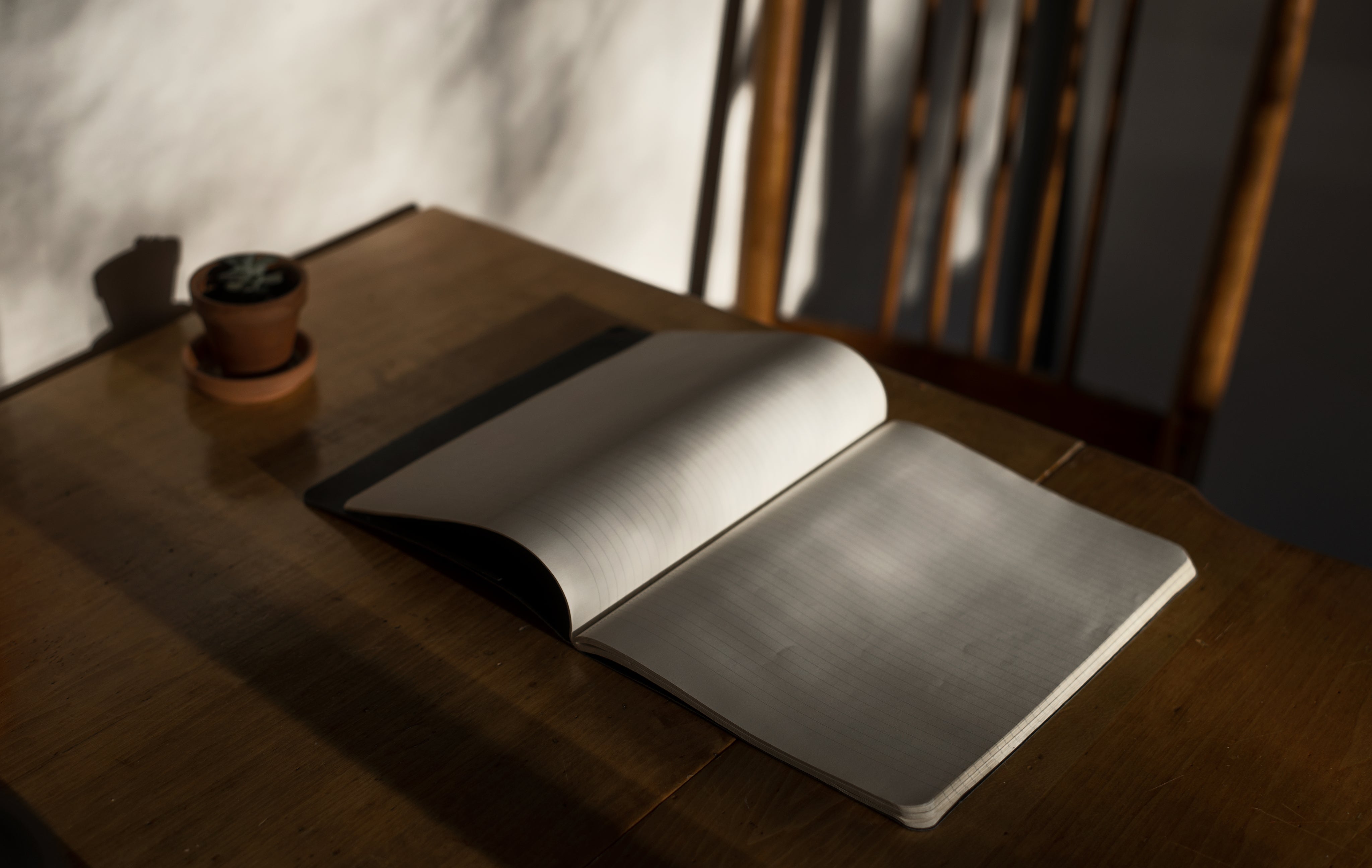 lined-notebook-lays-open-on-a-wooden-table.jpg